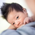 Breastfeeding baby with spiky black hair – Birth, Baby & You – Dee Bell – Lactation Consultant for Kent, Surrey & Sussex