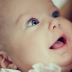 Happy baby looking up at mother during a feed – Birth, Baby & You – Dee Bell – Lactation Consultant for Kent, Surrey & Sussex